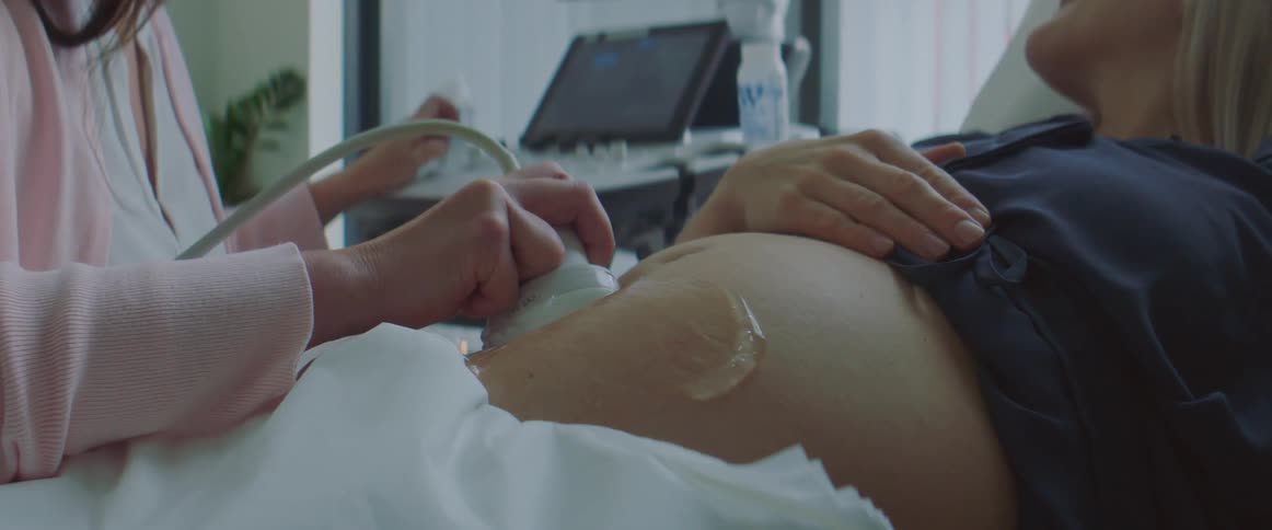 A woman is getting a sonogram in the hospital