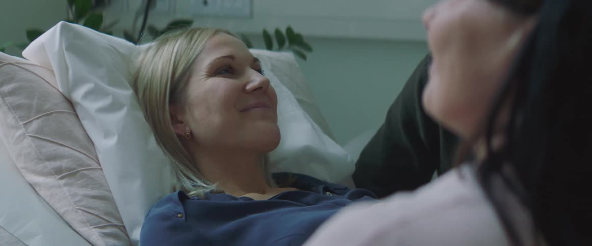 A woman smiling at a doctors appointment