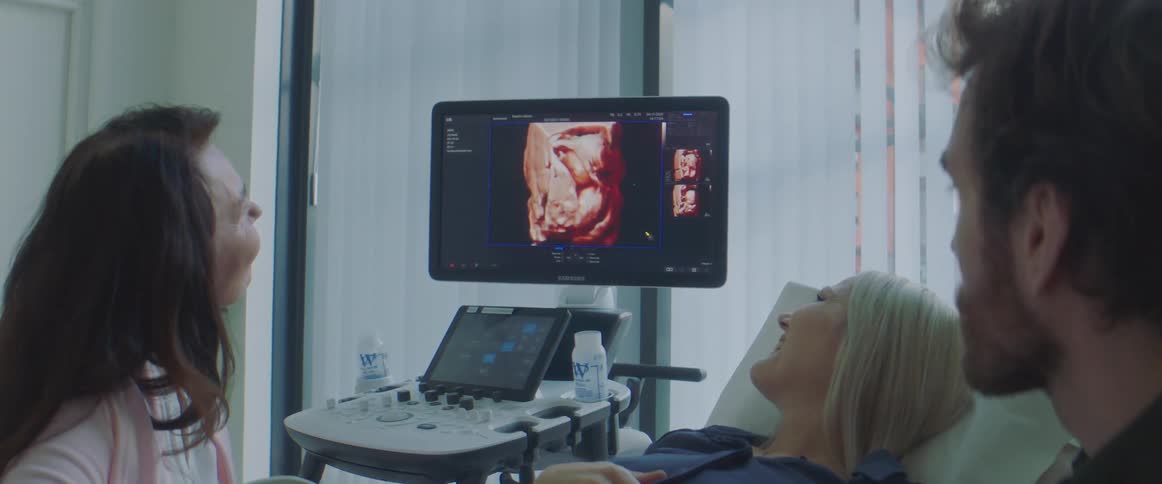 A doctor shows a patient her sonogram