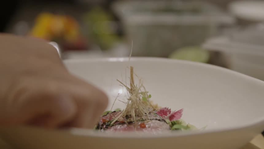 Food is being placed in a dish