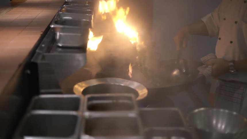 A chef is preparing food in a kitchen