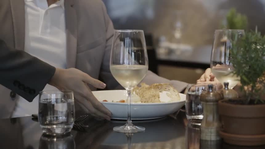 A plate of food is served to a seated man