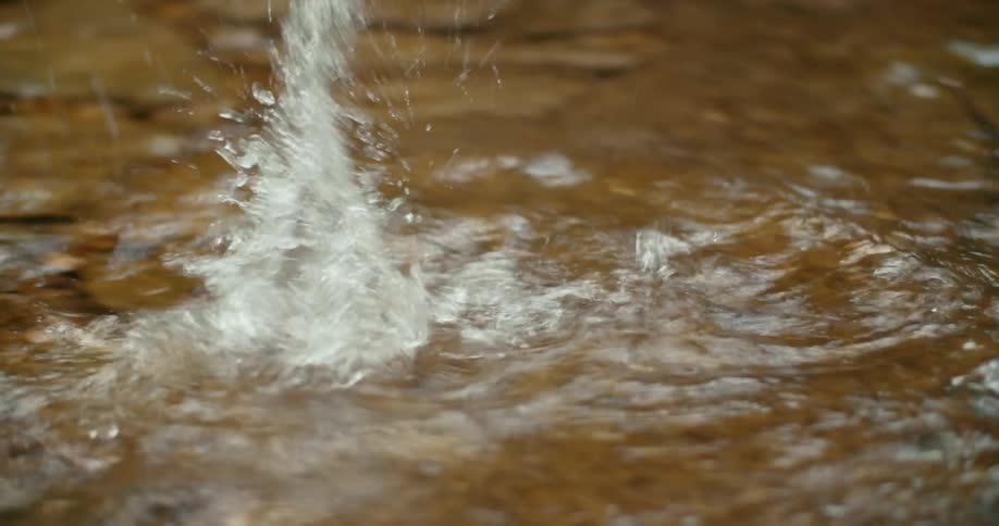 A person runs through the stream water