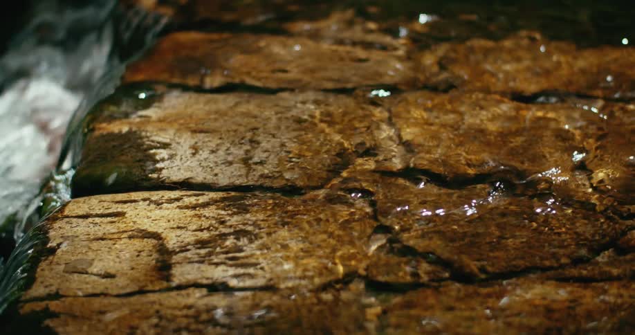 River water flows over stone bottom and falls a short way