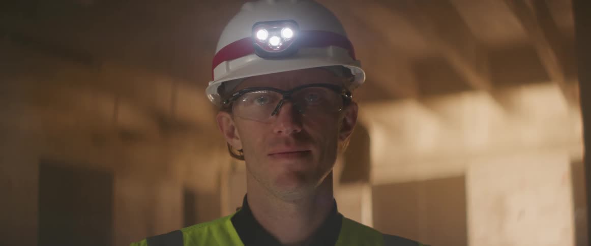 A construction worker is standing in the building