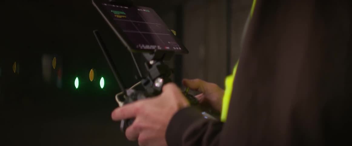 A man lands his drone on the ground