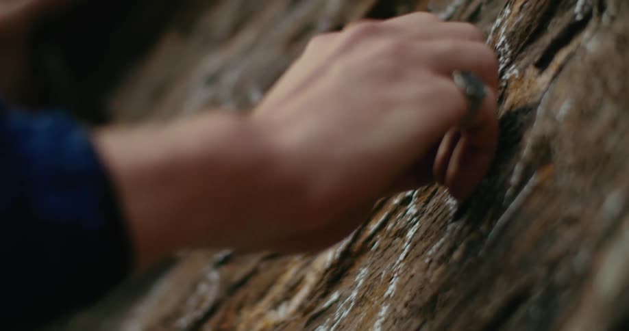 A person is drawing with chalk on the wood
