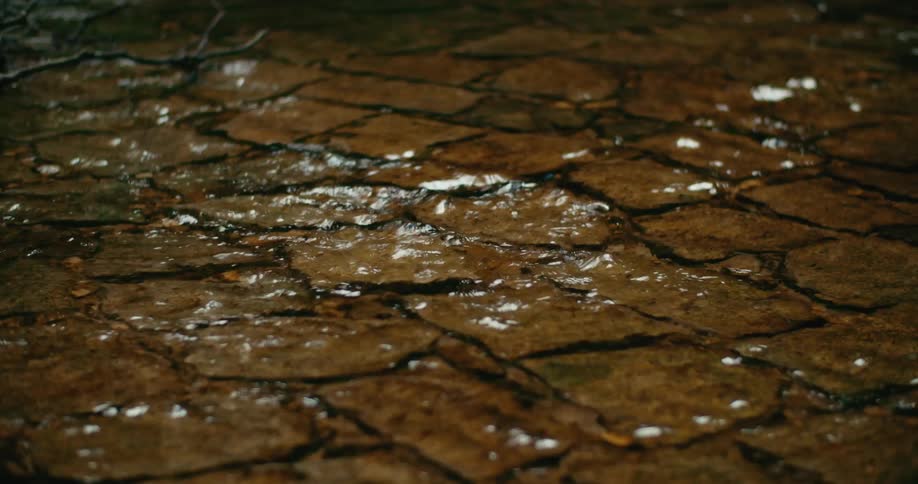 The water pours on the cobblestone