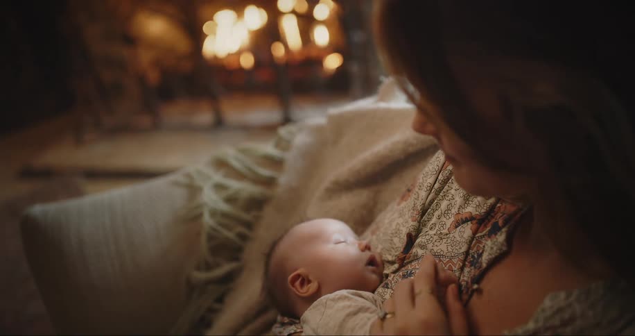 New mom with sleeping baby in her arms
