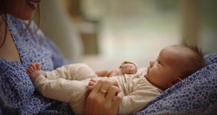 New mom holds her baby on in lap