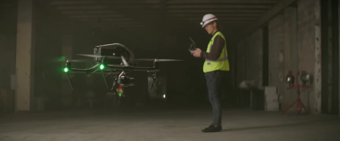 A man flies the drone in the building