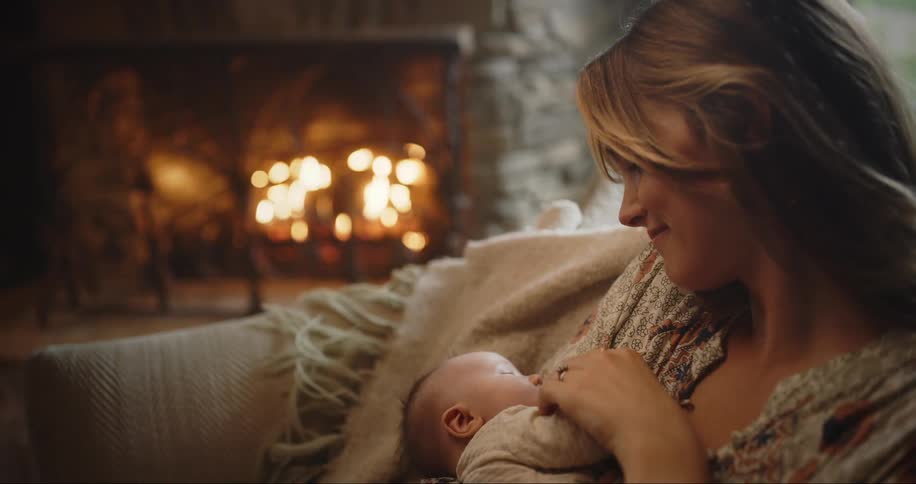 New mother cradles her son on the couch