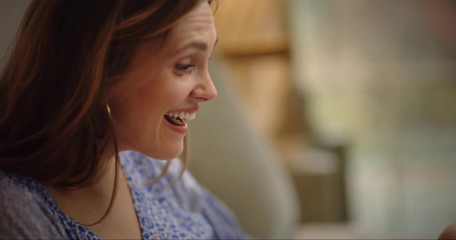 Mother smiles at baby in her lap