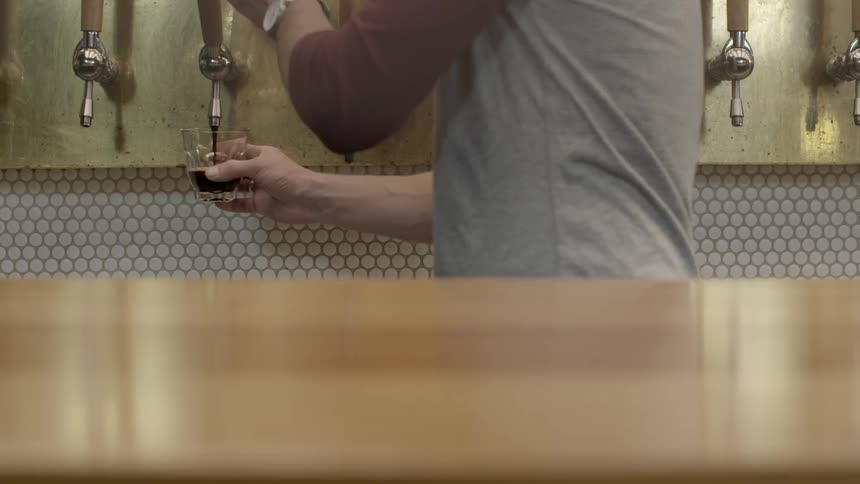 Person fills a glass half-full from a tap