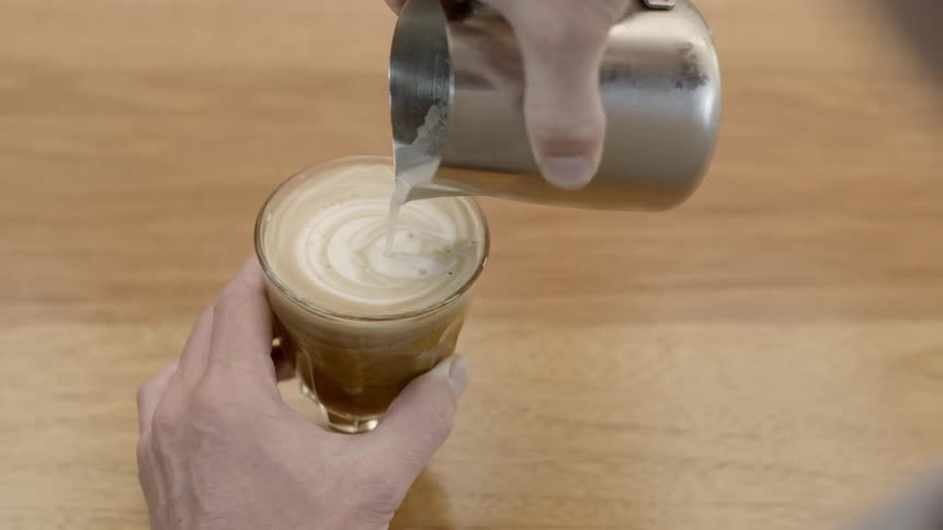 Cream is being poured into a glass