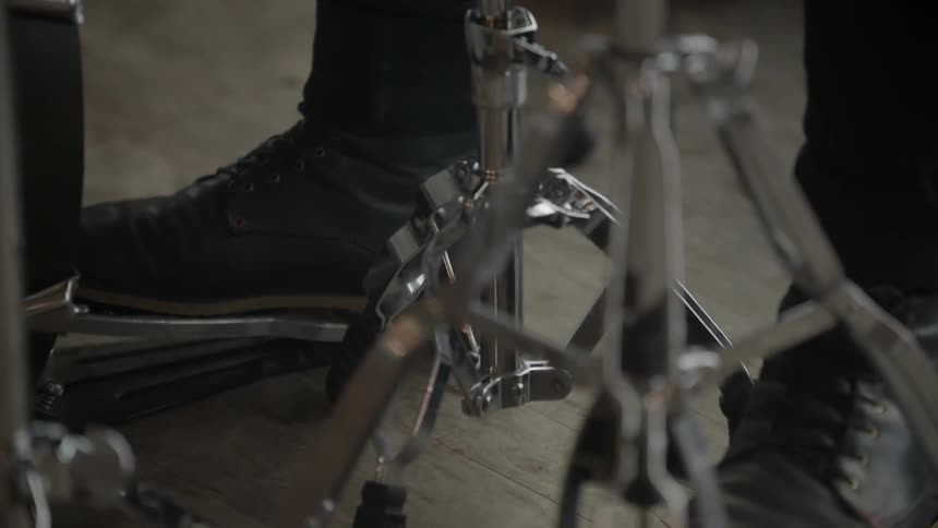Close up of feet working on a drum set