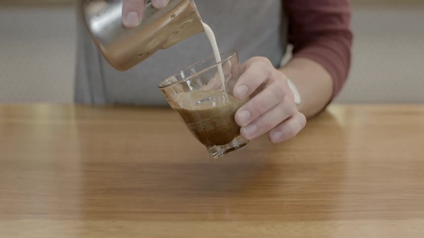 Cream is being poured into a glass
