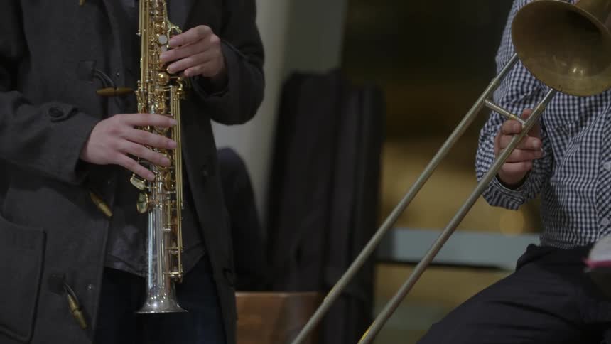Close up of people playing musical instruments