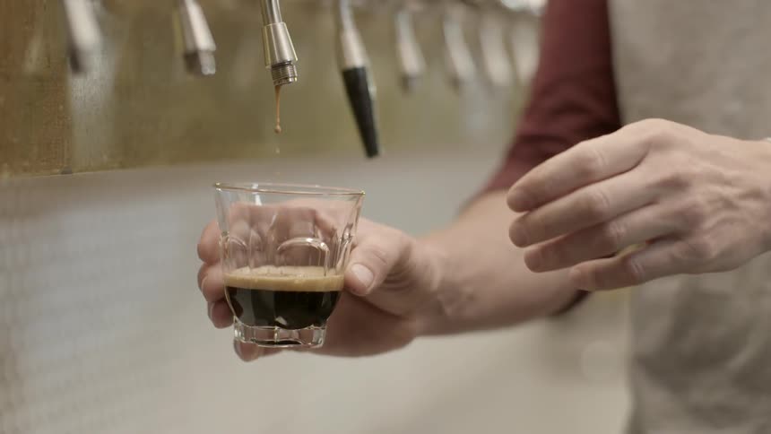 A man is filling a glass from a spout