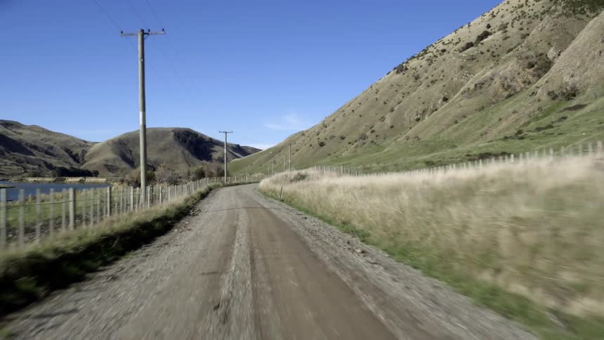Moving down a small dirt road by a lake