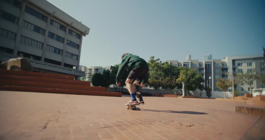 A man does a kickflip on his skateboard