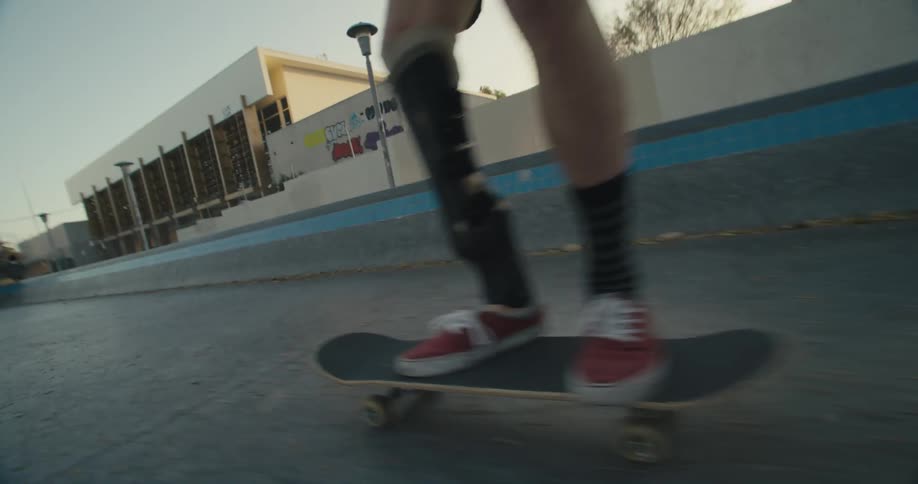 A man does a jump on the skateboard and tumbles