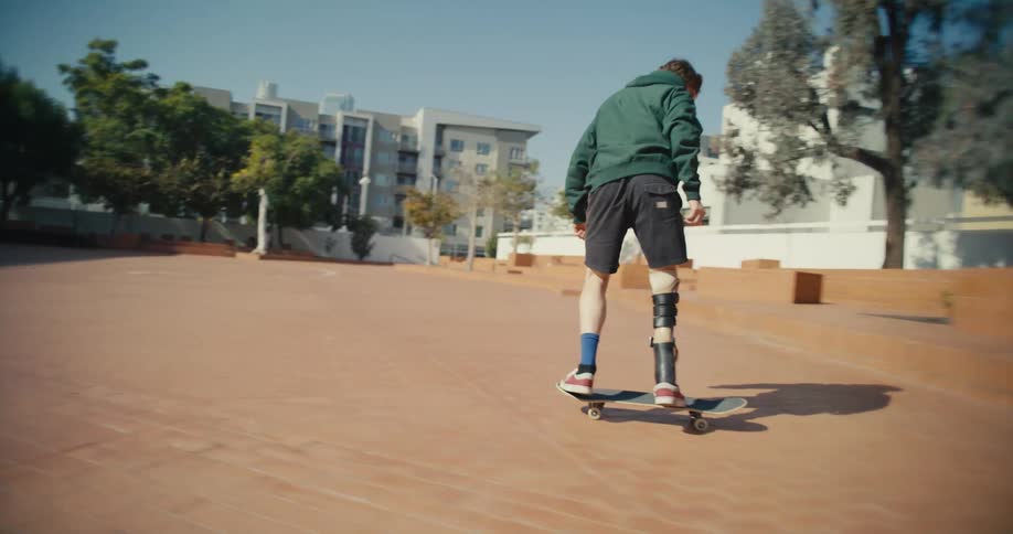 A skateboarder attempts to jump up on a step in a city plaza but fails
