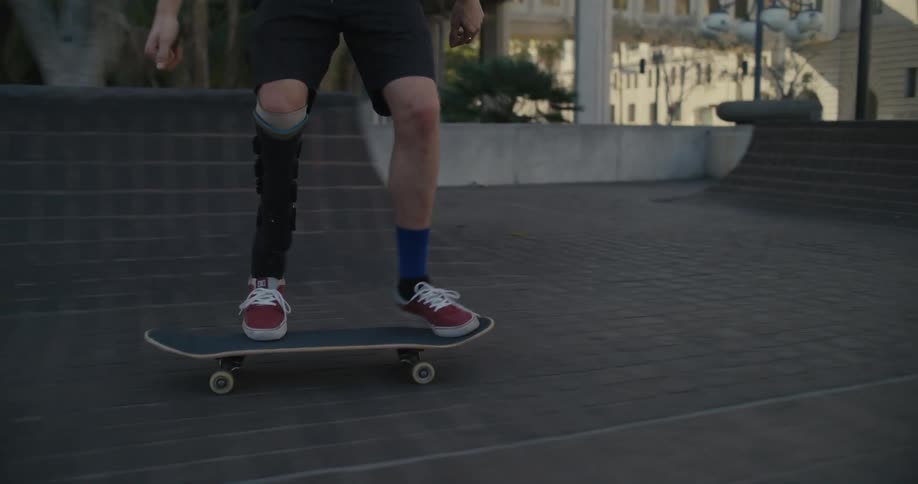 A person does a skateboard flip riding through a small town area