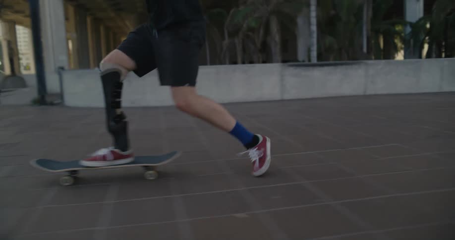 A teenager performs a kick flip stunt on a skateboard