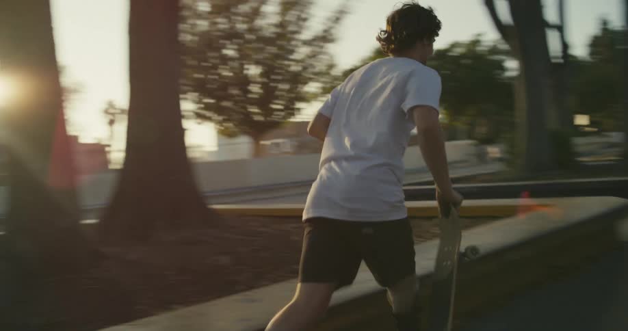 Two people skateboarding at a park