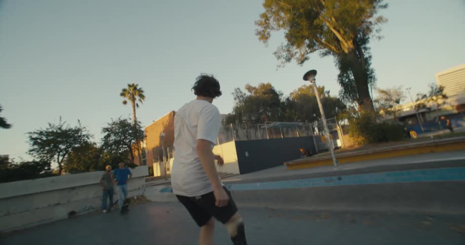 A skateboarder with a prosthetic leg performs a trick outside