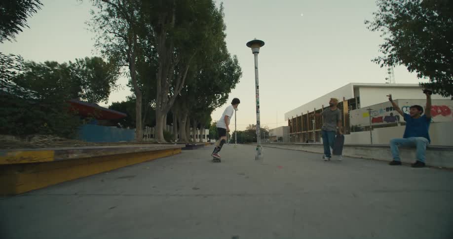 A person skateboarding with friends outdoors