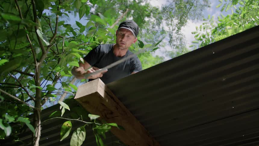 A man sawing a piece of wood
