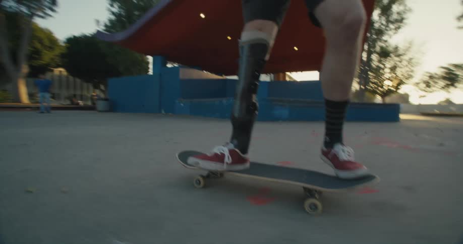 A man skateboarding and doing tricks at a park