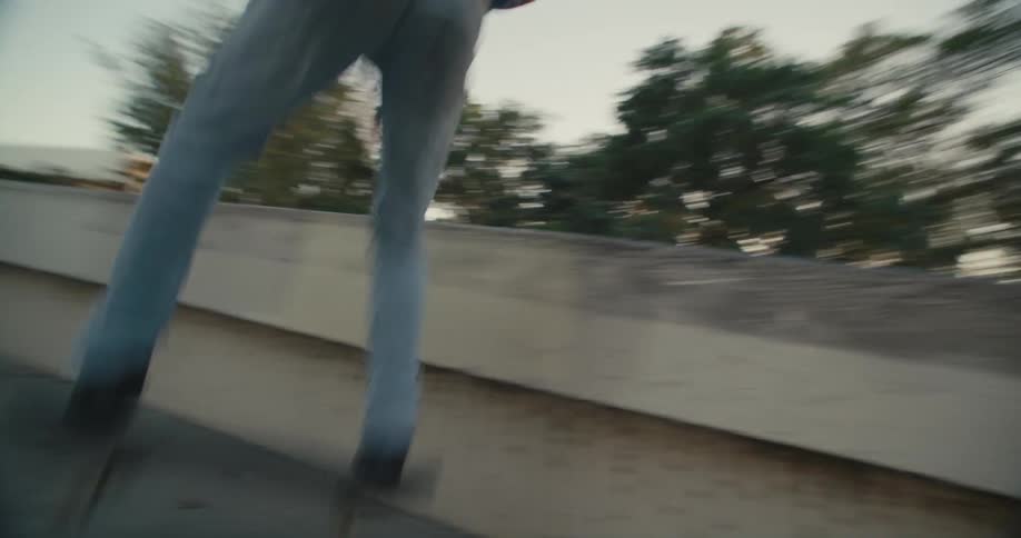 Skateboarder rides wall near stairs before jumping down then greeting friends
