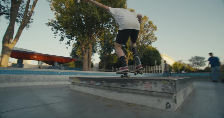 A group of people skateboarding in a park