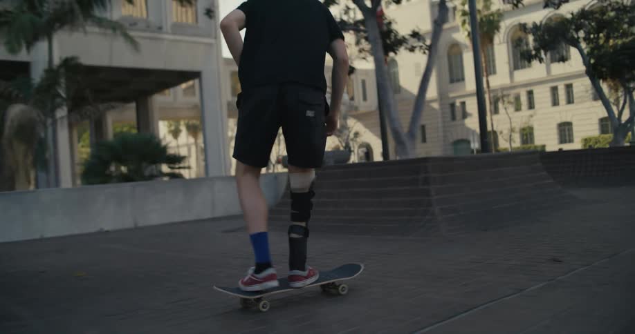 A person skateboards in a town concourse