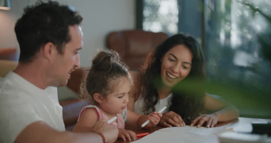 A family is sitting at the table together during the daytime