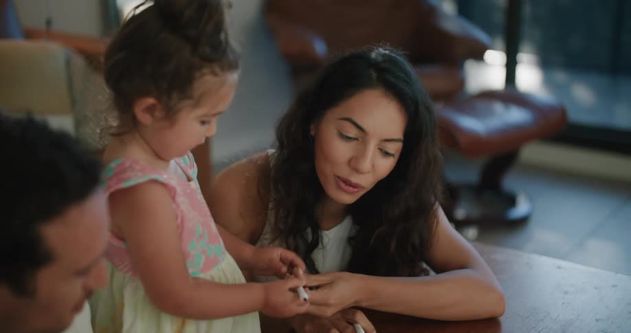 A family coloring together in a book
