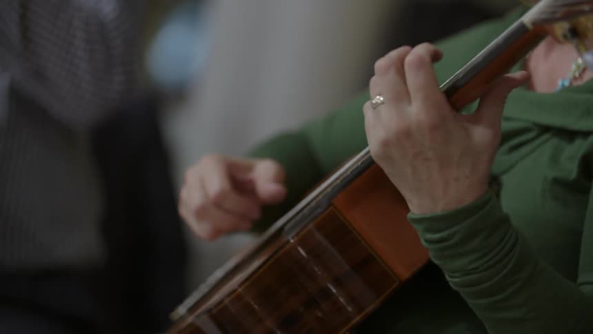 A woman is playing a guitar