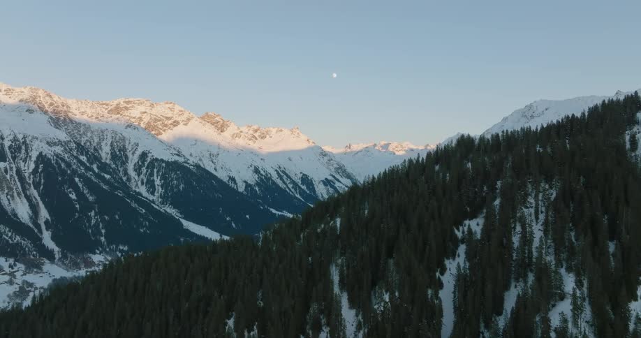 Snow and tree covered mountain slopes and ridges