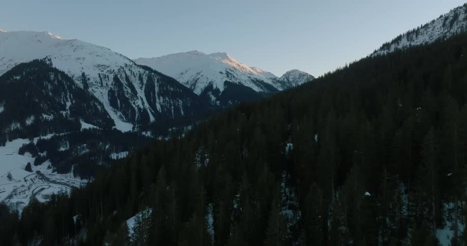 Conifer forest occupies portions of slopes in mountain range