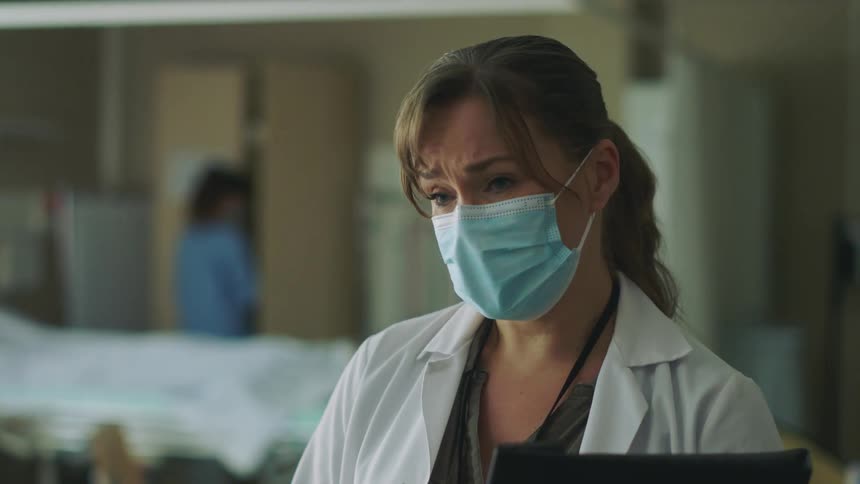 A female physician talking with a face mask
