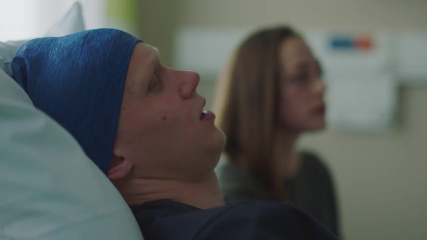 A visitor and patient hug in the hospital