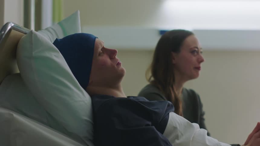 Patients relative sits up apprehensively to listen to results then starts crying