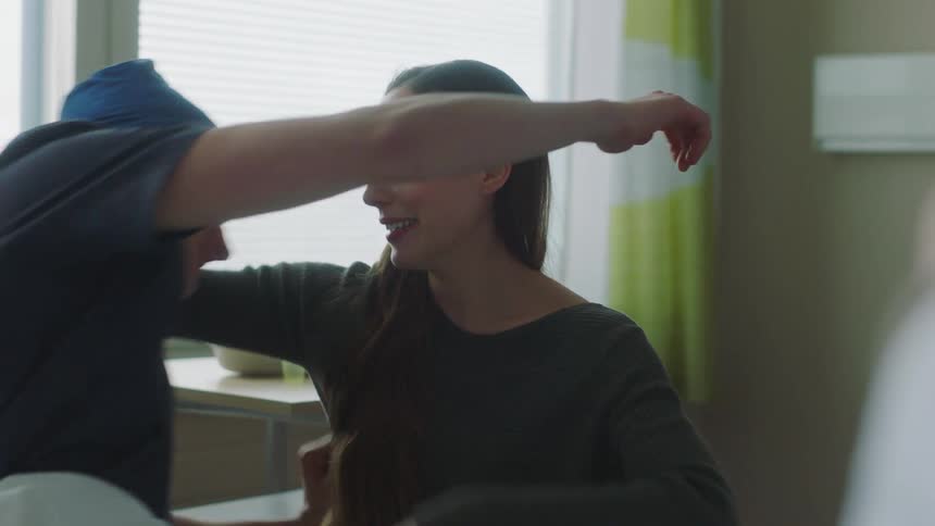A woman hugs her partner after he receives good news from a doctor