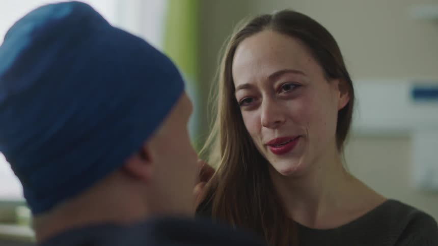 Man and woman are talking to each other inside a room
