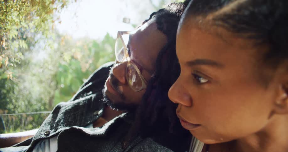 A man and woman sit together talking