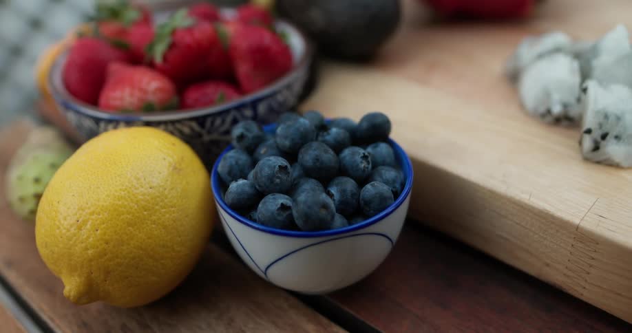 A person walks by fruit on a table