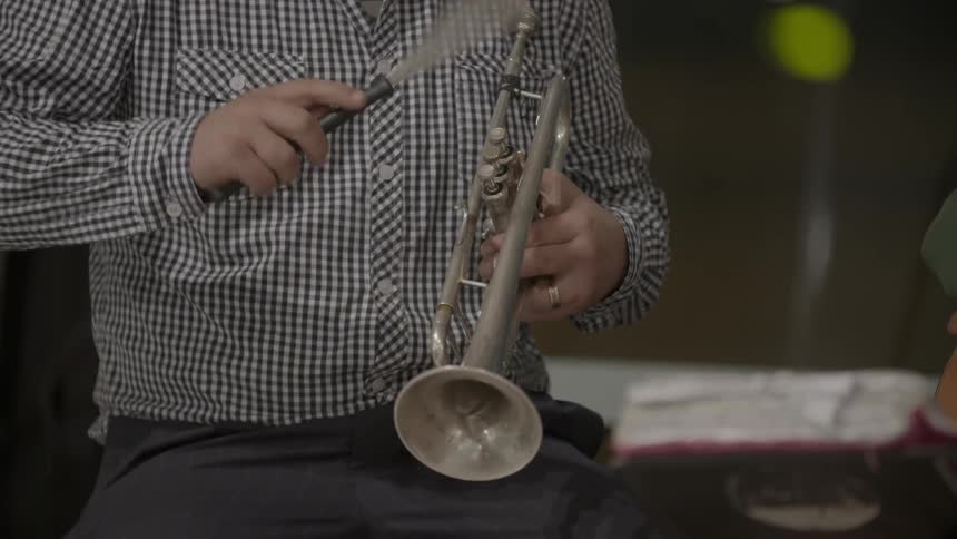 A man is tapping a musical instrument